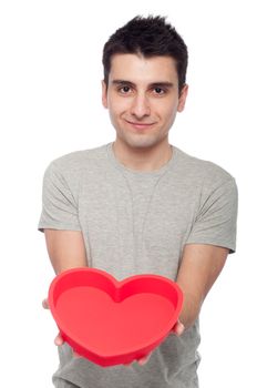 lovely portrait of a young man holding a red heart (isolated on white background)