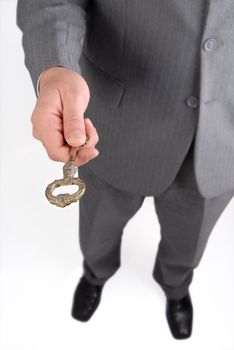 Businessman handing and giving a key to success