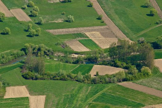 Beautiful idyllic river Bednja valley with agriculture layers