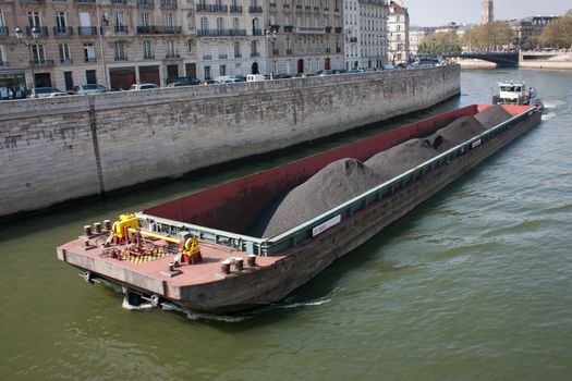 Canal boat shipping merchandise, on the river the Seine in Paris, France