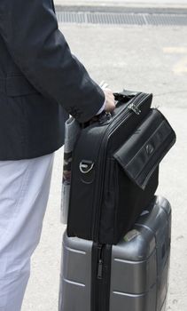 Businessman waiting his train, with newspaper and suitcase