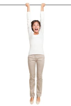 woman hanging with hands on a pole or bar. Funny image of shocked looking female model isolated on white background.