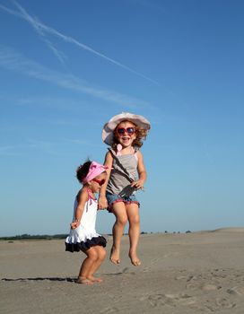 two happy little girl jumping