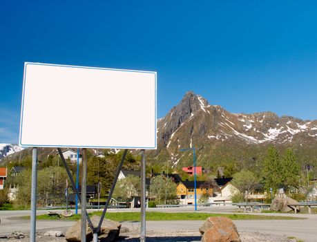 Big white billboard in the background of rocky mountains