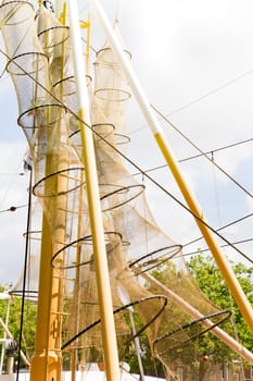 Part of fishing trawler with nets hanging in the mast