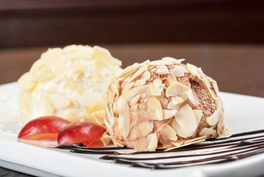 Dessert set of ice-cream with almond, chocolate and grapes