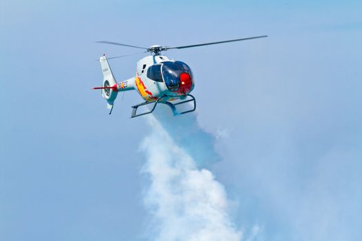 CADIZ, SPAIN-SEP 11: Helicopters of the Patrulla Aspa taking part in an exhibition on the 4th airshow of Cadiz on Sep 11, 2011, in Cadiz, Spain