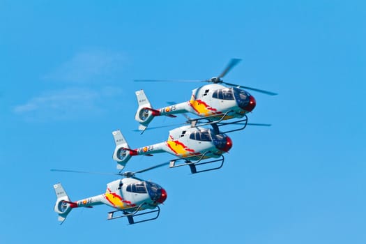 CADIZ, SPAIN-SEP 11: Helicopters of the Patrulla Aspa taking part in an exhibition on the 4th airshow of Cadiz on Sep 11, 2011, in Cadiz, Spain