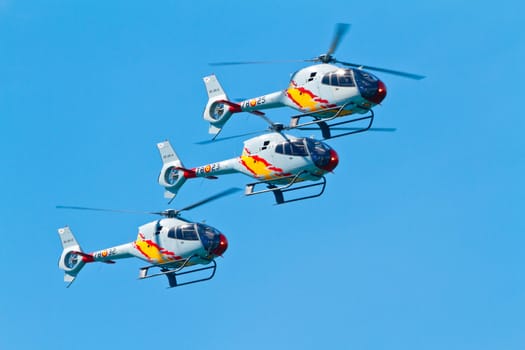 CADIZ, SPAIN-SEP 11: Helicopters of the Patrulla Aspa taking part in an exhibition on the 4th airshow of Cadiz on Sep 11, 2011, in Cadiz, Spain