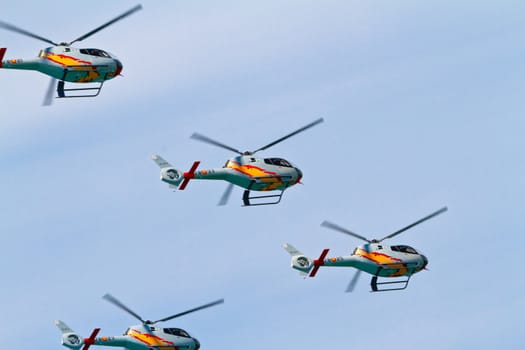 CADIZ, SPAIN-SEP 11: Helicopters of the Patrulla Aspa taking part in an exhibition on the 4th airshow of Cadiz on Sep 11, 2011, in Cadiz, Spain