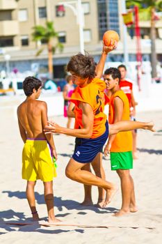 CADIZ, SPAIN - JULY 19: Unidentified players compete in a match between Autoescuela Barquin and CadizSur Seguros BMPY in the 19th league of beach handball of Cadiz on July 19, 2011 in Cadiz, Spain
