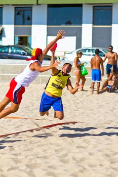 CADIZ, SPAIN - JULY 19: Unidentified players compete in a match between Los Negritos and Ademar Adentro in the 19th league of beach handball of Cadiz on July 19, 2011 in Cadiz, Spain