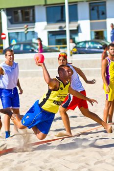 CADIZ, SPAIN - JULY 19: Unidentified players compete in a match between Los Negritos and Ademar Adentro in the 19th league of beach handball of Cadiz on July 19, 2011 in Cadiz, Spain