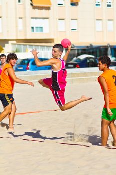 CADIZ, SPAIN - JULY 19: Unidentified players compete in a match between Autoescuela Barquin and CadizSur Seguros BMPY in the 19th league of beach handball of Cadiz on July 19, 2011 in Cadiz, Spain