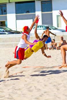 CADIZ, SPAIN - JULY 19: Unidentified players compete in a match between Los Negritos and Ademar Adentro in the 19th league of beach handball of Cadiz on July 19, 2011 in Cadiz, Spain