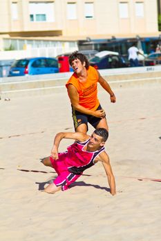 CADIZ, SPAIN - JULY 19: Unidentified players compete in a match between Autoescuela Barquin and CadizSur Seguros BMPY in the 19th league of beach handball of Cadiz on July 19, 2011 in Cadiz, Spain