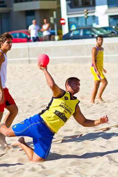 CADIZ, SPAIN - JULY 19: Unidentified players compete in a match between Los Negritos and Ademar Adentro in the 19th league of beach handball of Cadiz on July 19, 2011 in Cadiz, Spain