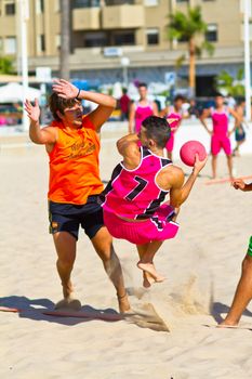 CADIZ, SPAIN - JULY 19: Unidentified players compete in a match between Autoescuela Barquin and CadizSur Seguros BMPY in the 19th league of beach handball of Cadiz on July 19, 2011 in Cadiz, Spain