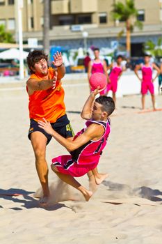 CADIZ, SPAIN - JULY 19: Unidentified players compete in a match between Autoescuela Barquin and CadizSur Seguros BMPY in the 19th league of beach handball of Cadiz on July 19, 2011 in Cadiz, Spain