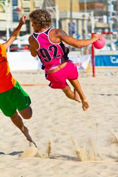 CADIZ, SPAIN - JULY 19: Unidentified players compete in a match between Autoescuela Barquin and CadizSur Seguros BMPY in the 19th league of beach handball of Cadiz on July 19, 2011 in Cadiz, Spain