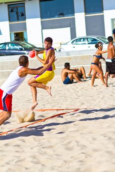 CADIZ, SPAIN - JULY 19: Unidentified players compete in a match between Los Negritos and Ademar Adentro in the 19th league of beach handball of Cadiz on July 19, 2011 in Cadiz, Spain
