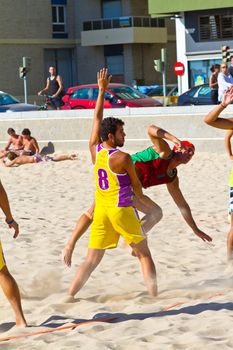 CADIZ, SPAIN - JULY 19: Unidentified players compete in a match between Los Negritos and Ademar Adentro in the 19th league of beach handball of Cadiz on July 19, 2011 in Cadiz, Spain