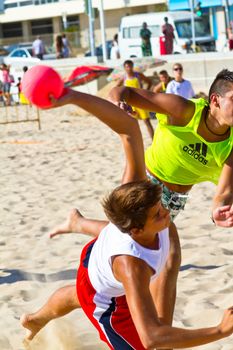 CADIZ, SPAIN - JULY 19: Unidentified players compete in a match between Los Negritos and Ademar Adentro in the 19th league of beach handball of Cadiz on July 19, 2011 in Cadiz, Spain