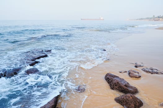 Smooth wave on the sandy beach in the morning