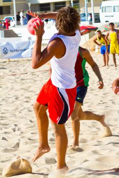 CADIZ, SPAIN - JULY 19: Unidentified players compete in a match between Los Negritos and Ademar Adentro in the 19th league of beach handball of Cadiz on July 19, 2011 in Cadiz, Spain