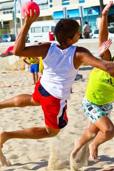 CADIZ, SPAIN - JULY 19: Unidentified players compete in a match between Los Negritos and Ademar Adentro in the 19th league of beach handball of Cadiz on July 19, 2011 in Cadiz, Spain
