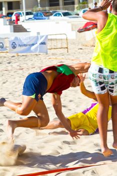 CADIZ, SPAIN - JULY 19: Unidentified players compete in a match between Los Negritos and Ademar Adentro in the 19th league of beach handball of Cadiz on July 19, 2011 in Cadiz, Spain