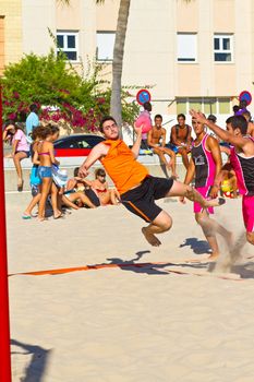 CADIZ, SPAIN - JULY 19: Unidentified players compete in a match between Autoescuela Barquin and CadizSur Seguros BMPY in the 19th league of beach handball of Cadiz on July 19, 2011 in Cadiz, Spain