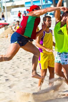 CADIZ, SPAIN - JULY 19: Unidentified players compete in a match between Los Negritos and Ademar Adentro in the 19th league of beach handball of Cadiz on July 19, 2011 in Cadiz, Spain