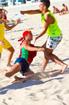 CADIZ, SPAIN - JULY 19: Unidentified players compete in a match between Los Negritos and Ademar Adentro in the 19th league of beach handball of Cadiz on July 19, 2011 in Cadiz, Spain