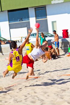 CADIZ, SPAIN - JULY 19: Unidentified players compete in a match between Los Negritos and Ademar Adentro in the 19th league of beach handball of Cadiz on July 19, 2011 in Cadiz, Spain