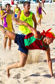 CADIZ, SPAIN - JULY 19: Unidentified players compete in a match between Los Negritos and Ademar Adentro in the 19th league of beach handball of Cadiz on July 19, 2011 in Cadiz, Spain