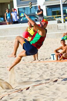 CADIZ, SPAIN - JULY 19: Unidentified players compete in a match between Los Negritos and Ademar Adentro in the 19th league of beach handball of Cadiz on July 19, 2011 in Cadiz, Spain