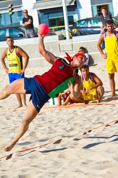 CADIZ, SPAIN - JULY 19: Unidentified players compete in a match between Los Negritos and Ademar Adentro in the 19th league of beach handball of Cadiz on July 19, 2011 in Cadiz, Spain
