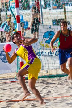 CADIZ, SPAIN - JULY 19: Unidentified players compete in a match between Los Negritos and Ademar Adentro in the 19th league of beach handball of Cadiz on July 19, 2011 in Cadiz, Spain