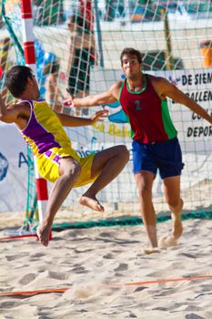CADIZ, SPAIN - JULY 19: Unidentified players compete in a match between Los Negritos and Ademar Adentro in the 19th league of beach handball of Cadiz on July 19, 2011 in Cadiz, Spain