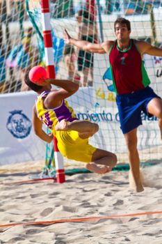 CADIZ, SPAIN - JULY 19: Unidentified players compete in a match between Los Negritos and Ademar Adentro in the 19th league of beach handball of Cadiz on July 19, 2011 in Cadiz, Spain