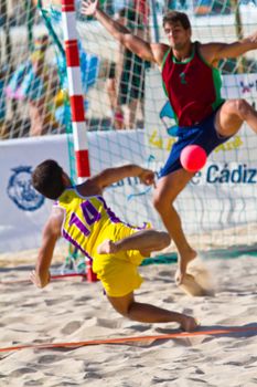 CADIZ, SPAIN - JULY 19: Unidentified players compete in a match between Los Negritos and Ademar Adentro in the 19th league of beach handball of Cadiz on July 19, 2011 in Cadiz, Spain