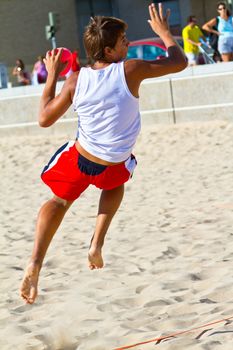CADIZ, SPAIN - JULY 19: Unidentified players compete in a match between Los Negritos and Ademar Adentro in the 19th league of beach handball of Cadiz on July 19, 2011 in Cadiz, Spain