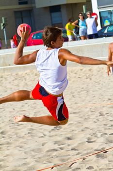 CADIZ, SPAIN - JULY 19: Unidentified players compete in a match between Los Negritos and Ademar Adentro in the 19th league of beach handball of Cadiz on July 19, 2011 in Cadiz, Spain