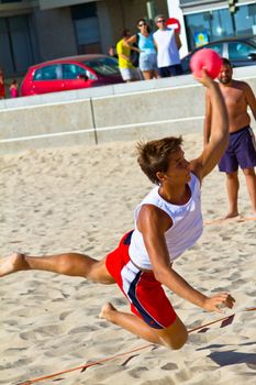 CADIZ, SPAIN - JULY 19: Unidentified players compete in a match between Los Negritos and Ademar Adentro in the 19th league of beach handball of Cadiz on July 19, 2011 in Cadiz, Spain