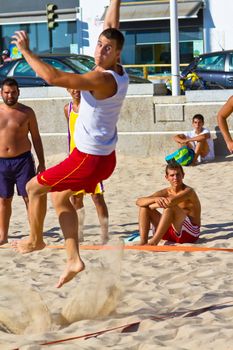 CADIZ, SPAIN - JULY 19: Unidentified players compete in a match between Los Negritos and Ademar Adentro in the 19th league of beach handball of Cadiz on July 19, 2011 in Cadiz, Spain