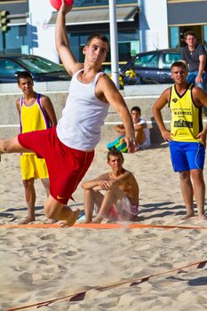 CADIZ, SPAIN - JULY 19: Unidentified players compete in a match between Los Negritos and Ademar Adentro in the 19th league of beach handball of Cadiz on July 19, 2011 in Cadiz, Spain