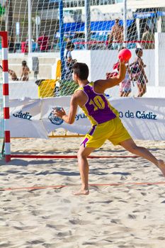 CADIZ, SPAIN - JULY 19: Unidentified players compete in a match between Los Negritos and Ademar Adentro in the 19th league of beach handball of Cadiz on July 19, 2011 in Cadiz, Spain