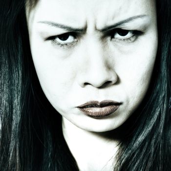 Studio portrait of a asian girl looking mad