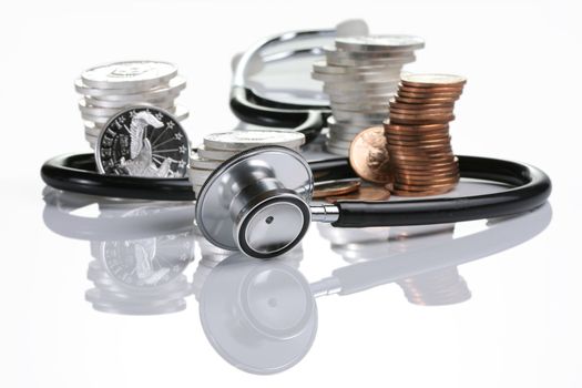 Financial health, stethoscope weaving around stack of silver and gold coins